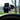 Phone showing the time in a Scanstrut ROKK Mini suction-cup mount on a window, close view of the clamp arm