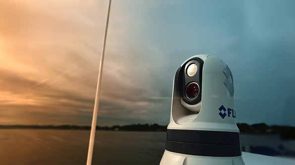 FLIR dome camera on a white mast at sunset, shown for Scanstrut CAM-PT-150-01-BLK camera PowerTower, mount not visible