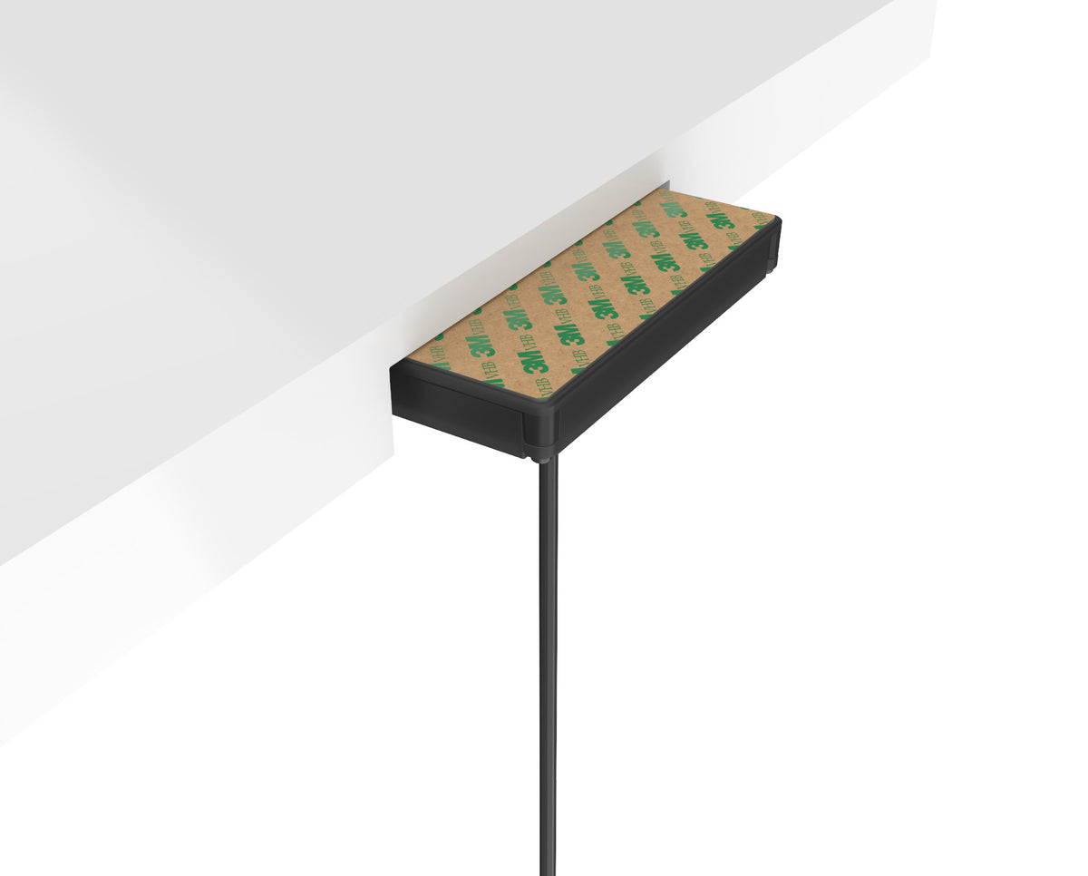 Scanstrut SC-CW-1GT hidden wireless charger stuck under a white tabletop with adhesive pad and cable