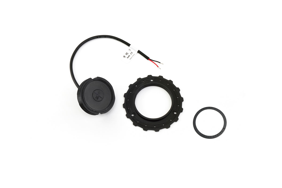 Scanstrut ROKK wireless hidden charger SC-CW-01F, black puck with cable, serrated locking ring and seal ring on white