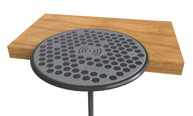 Scanstrut ROKK SC-CW-02F round wireless charging pad set into the edge of a wooden shelf, cable below