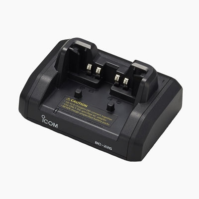 Icom BC-226 connectable type charger, black two-slot cradle with the Icom logo and a caution label