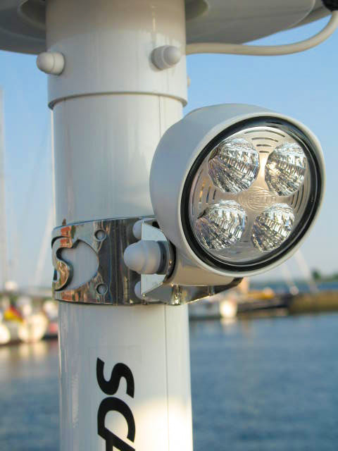 Scanstrut SC117 deck flood light with four LEDs in a white housing, clamped to a white mast with a steel bracket